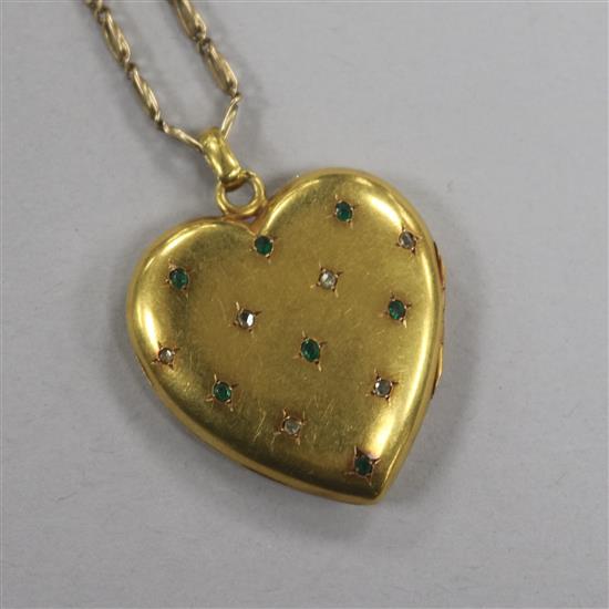 A Victorian yellow metal and gem set heart shaped pendant locket, on a later 9ct gold chain, locket 31mm.